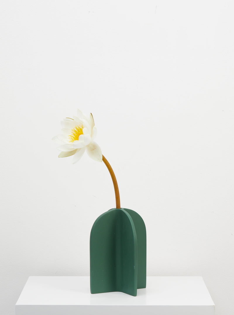 green vase with flower